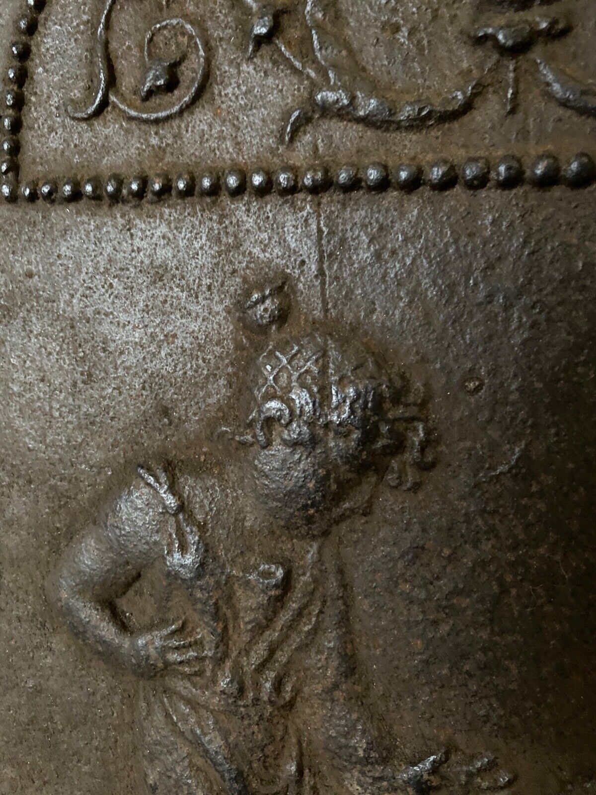 EIGHTEENTH CENTURY CAST IRON FIREPLACE PLATE REPRESENTING A WOMAN AND A WOLF