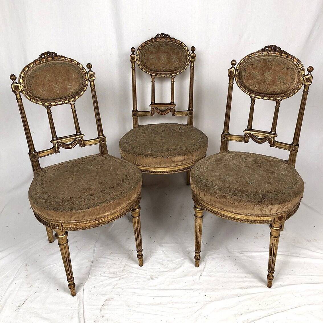 Series of three Louis XVI style chairs in gilded wood, circa 1900