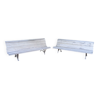 Pair of antique wooden slatted benches with wrought iron legs.
