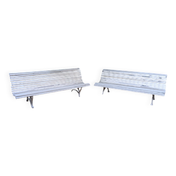 Pair of antique wooden slatted benches with wrought iron legs.