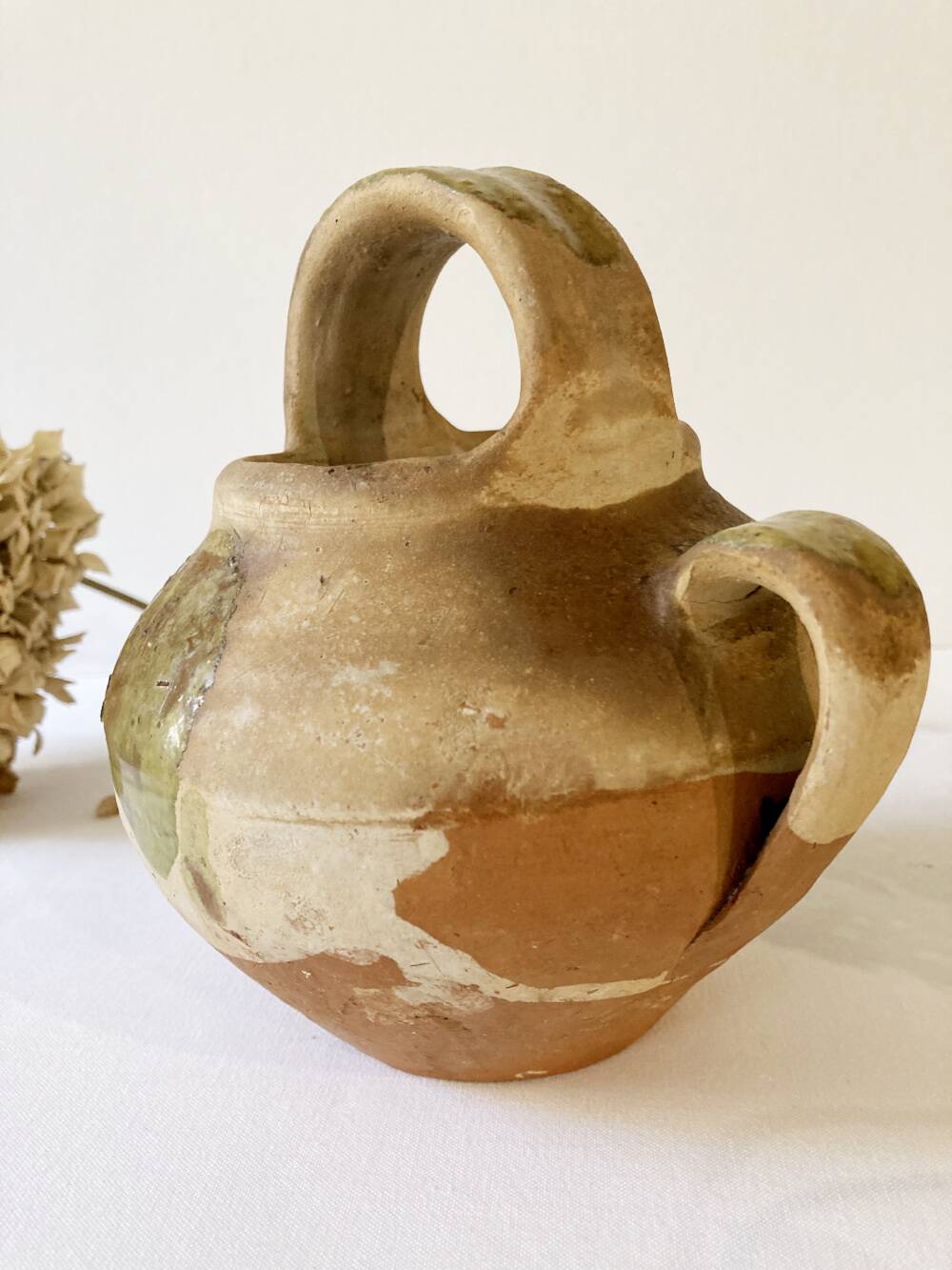 Small Provençal goat jug in creamy white and green enamelled stoneware