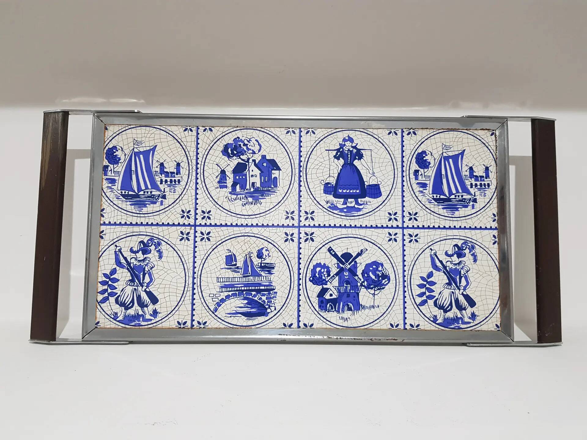 Heating plate, blue and white ceramic, brown rosewood, black metal, Germany, 1970s.