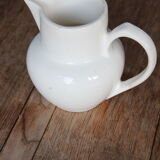 Old pitcher in white earthenware