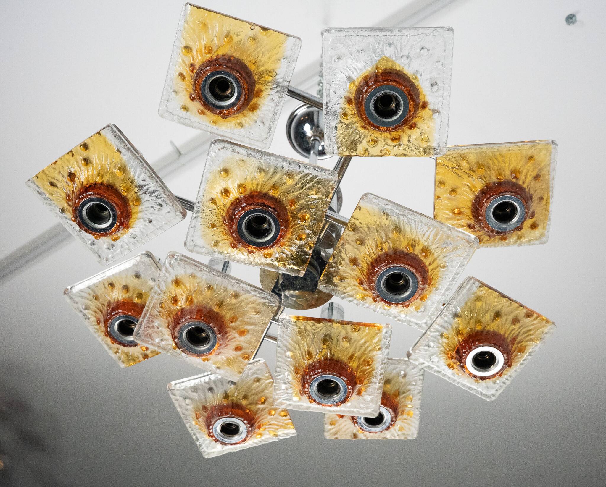 12-light Mazzega chandelier in amber and clear murano glass and chrome. Ita
