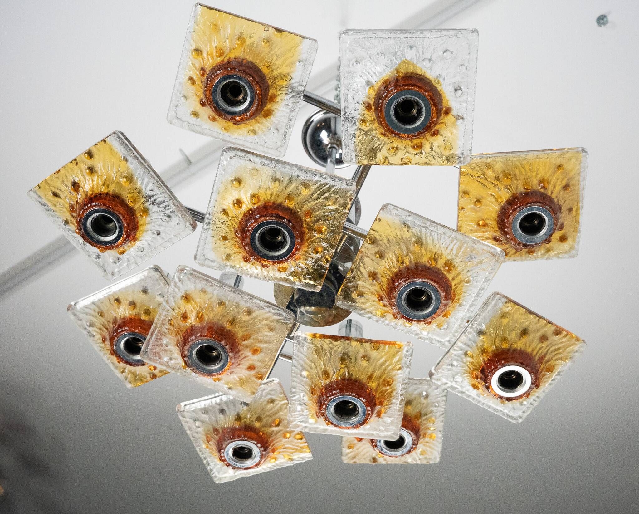 12-light Mazzega chandelier in amber and clear murano glass and chrome. Ita