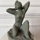 Sculpture of a naked woman titled "Youth" in terracotta.