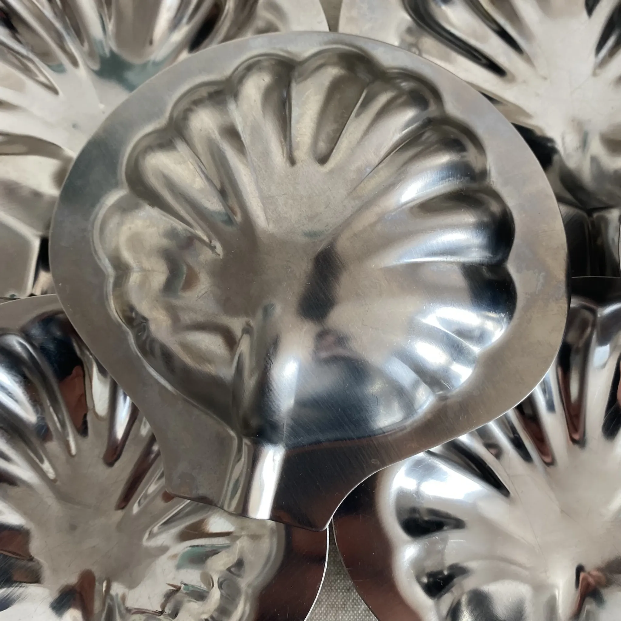 Set of 12 stainless steel scallop shells, 1970s-80s.