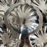 Set of 12 stainless steel scallop shells, 1970s-80s.