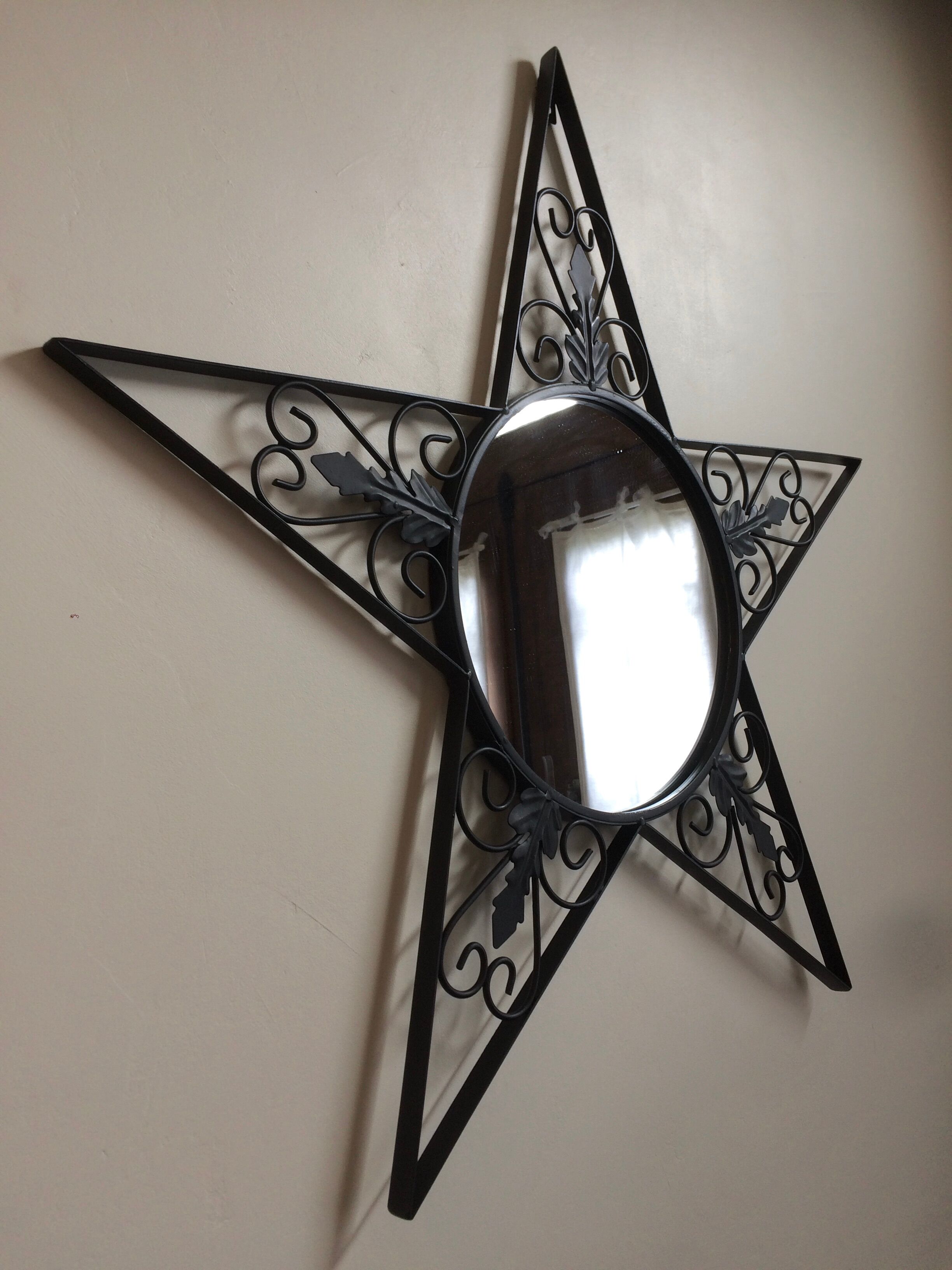 Star-shaped wrought iron round mirror