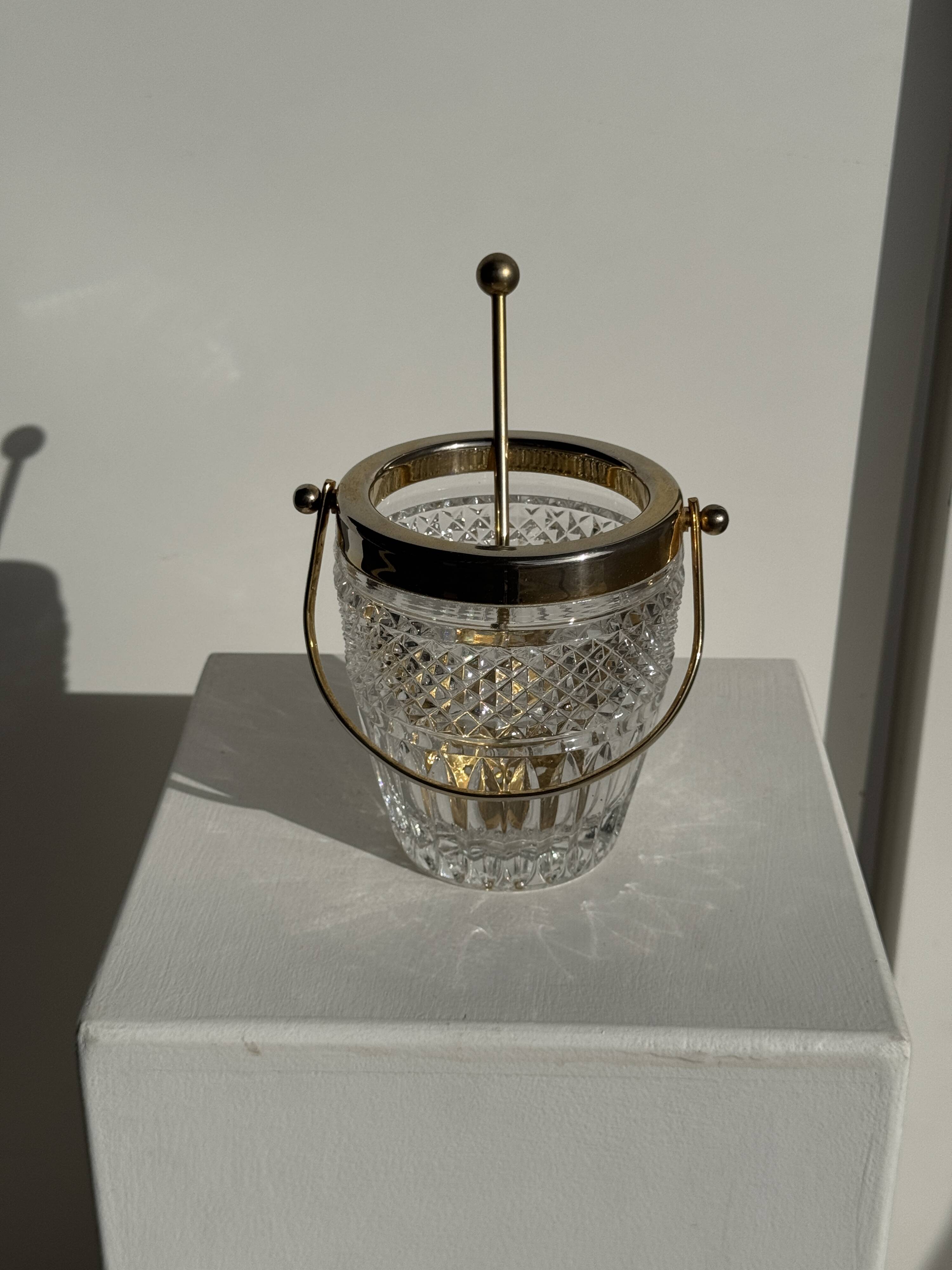 Small golden glass ice bucket with diamond point design and its scoop.