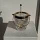 Small golden glass ice bucket with diamond point design and its scoop.