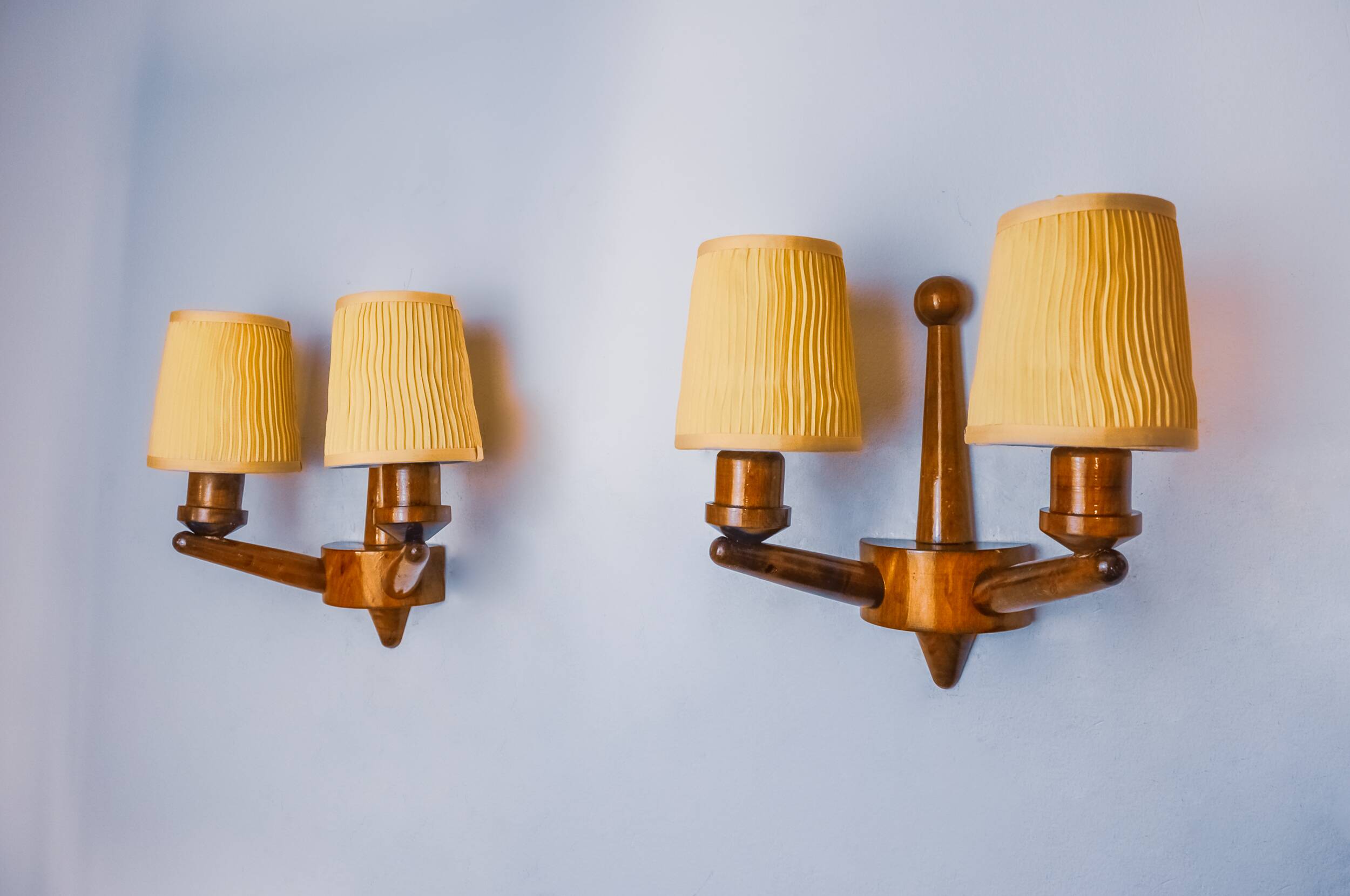 Pair of two-armed art deco "ball" wall lights, carved wood, France, 1960