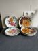 Italian ceramic plates with floral fruit designs.