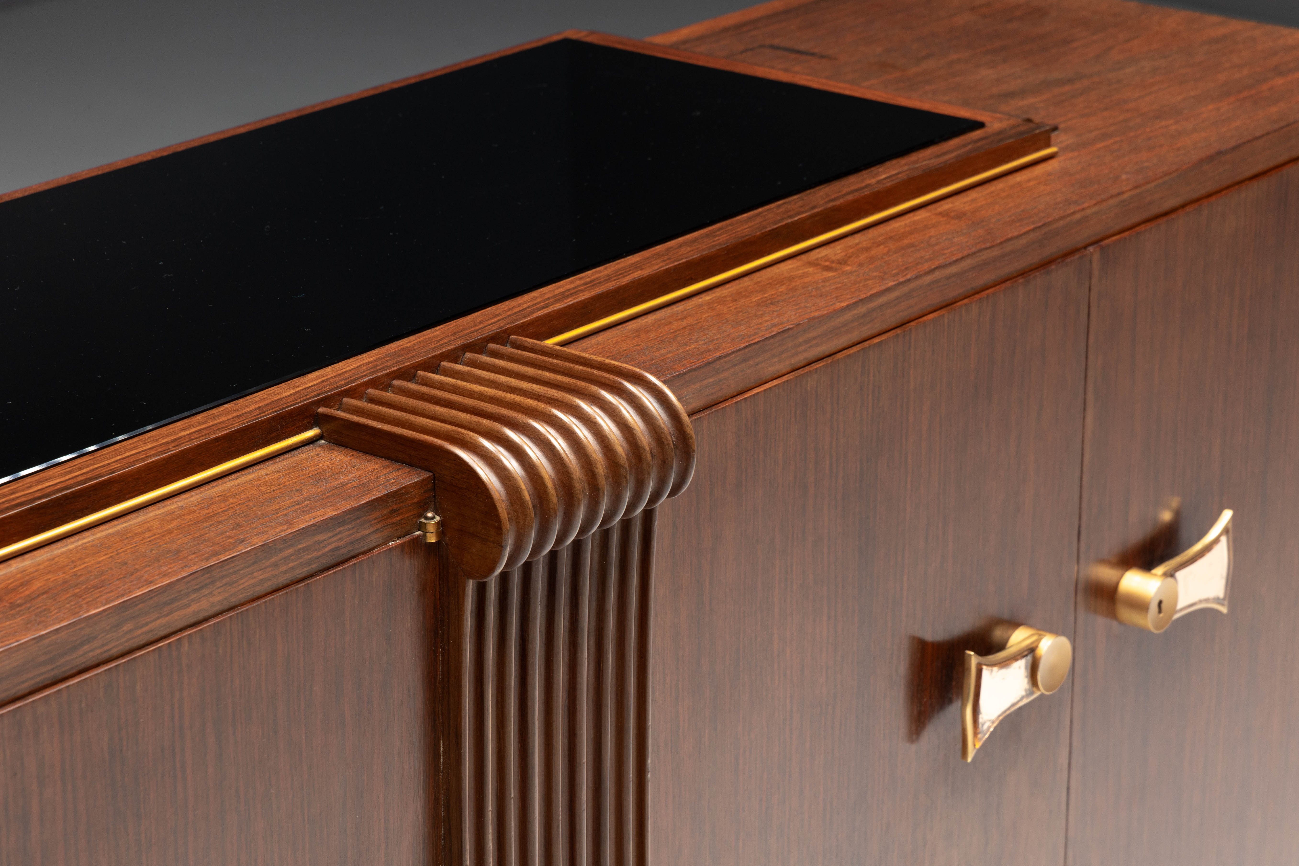 Art Deco walnut sideboard with brass details and sculptural base, France, 1930s