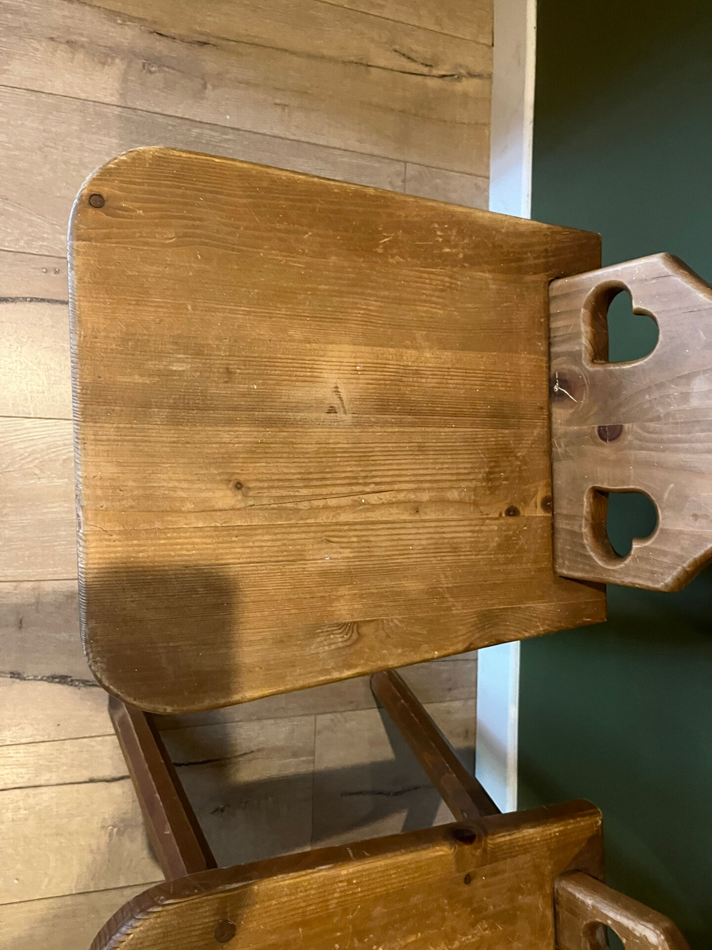 Pair of vintage wooden chairs in alpine chalet style.