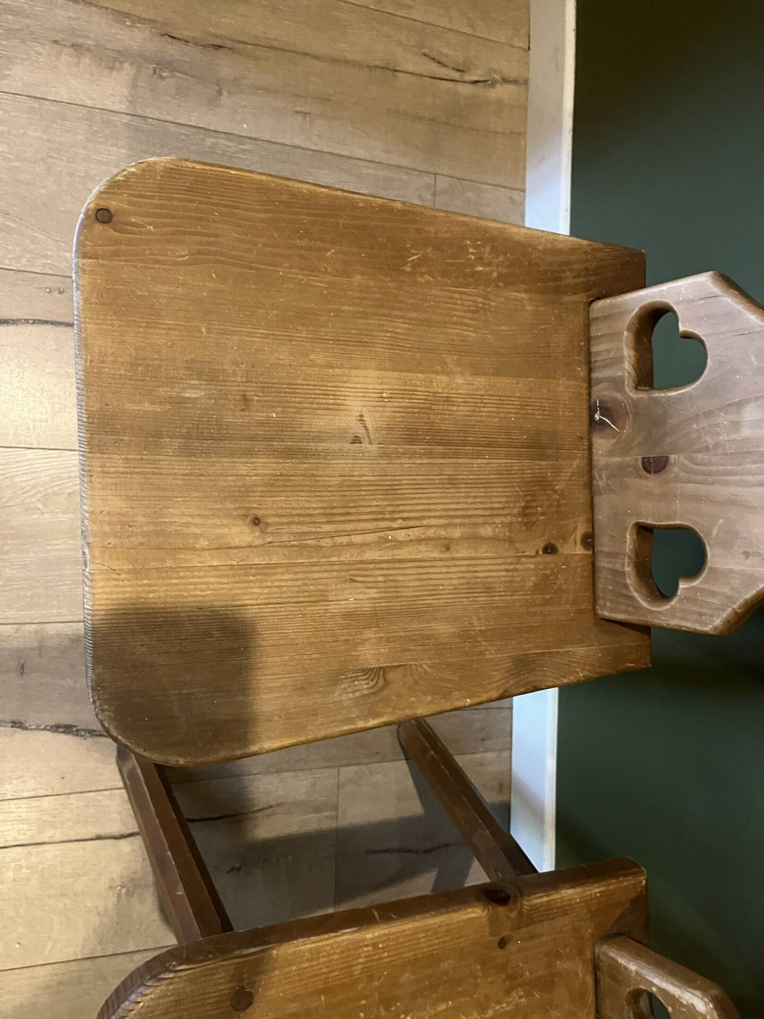 Pair of vintage wooden chairs in alpine chalet style.