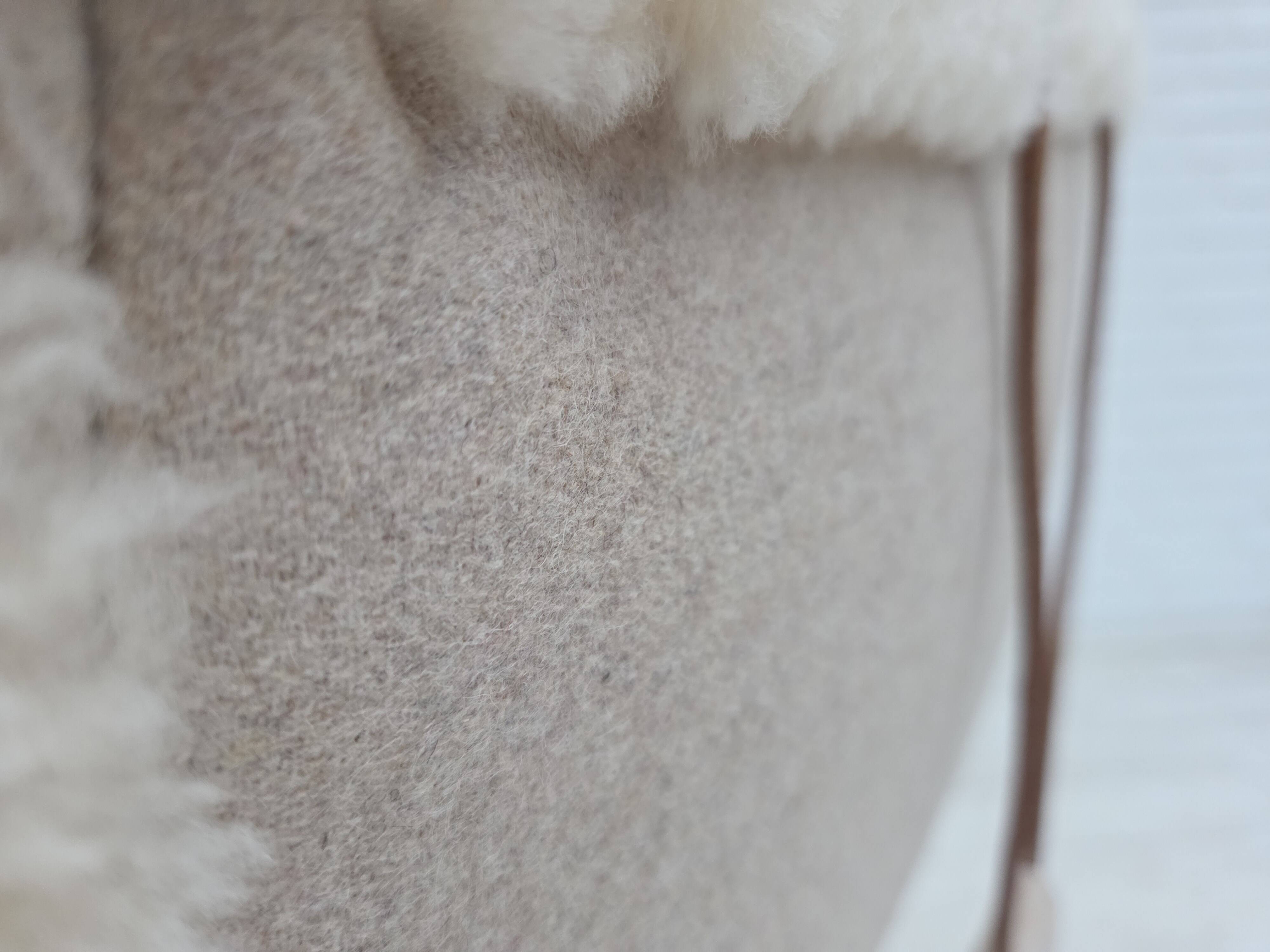 1970s, Danish rocking chair, reupholstered in quality genuine sheepskin.