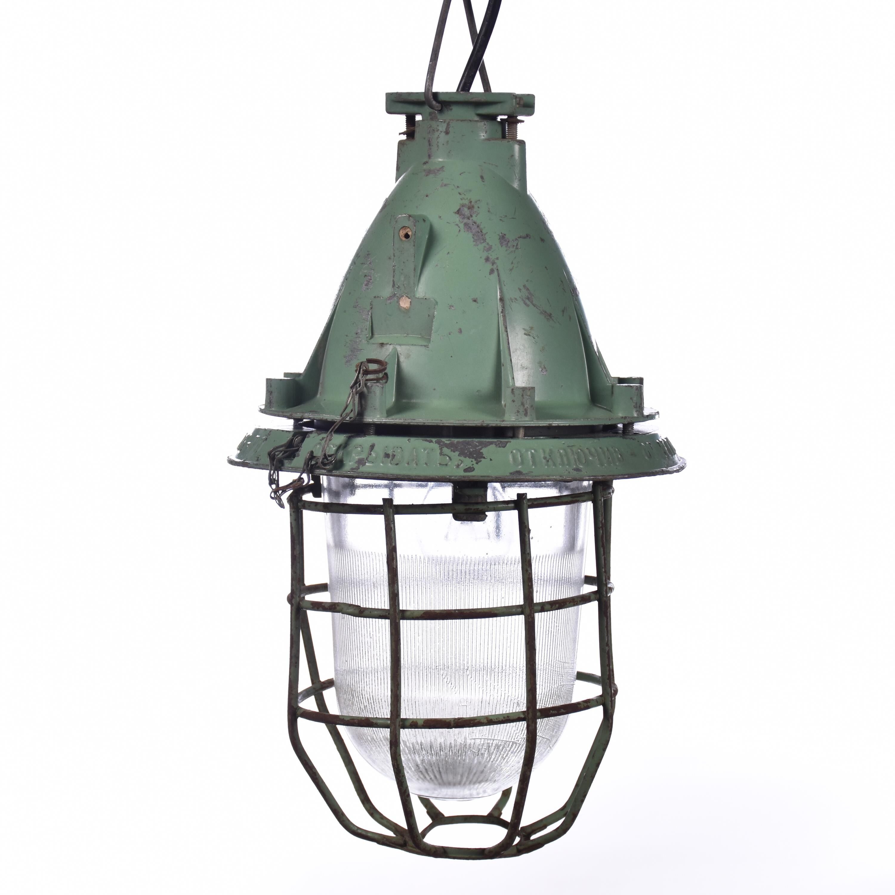 Industrial caged green lamp