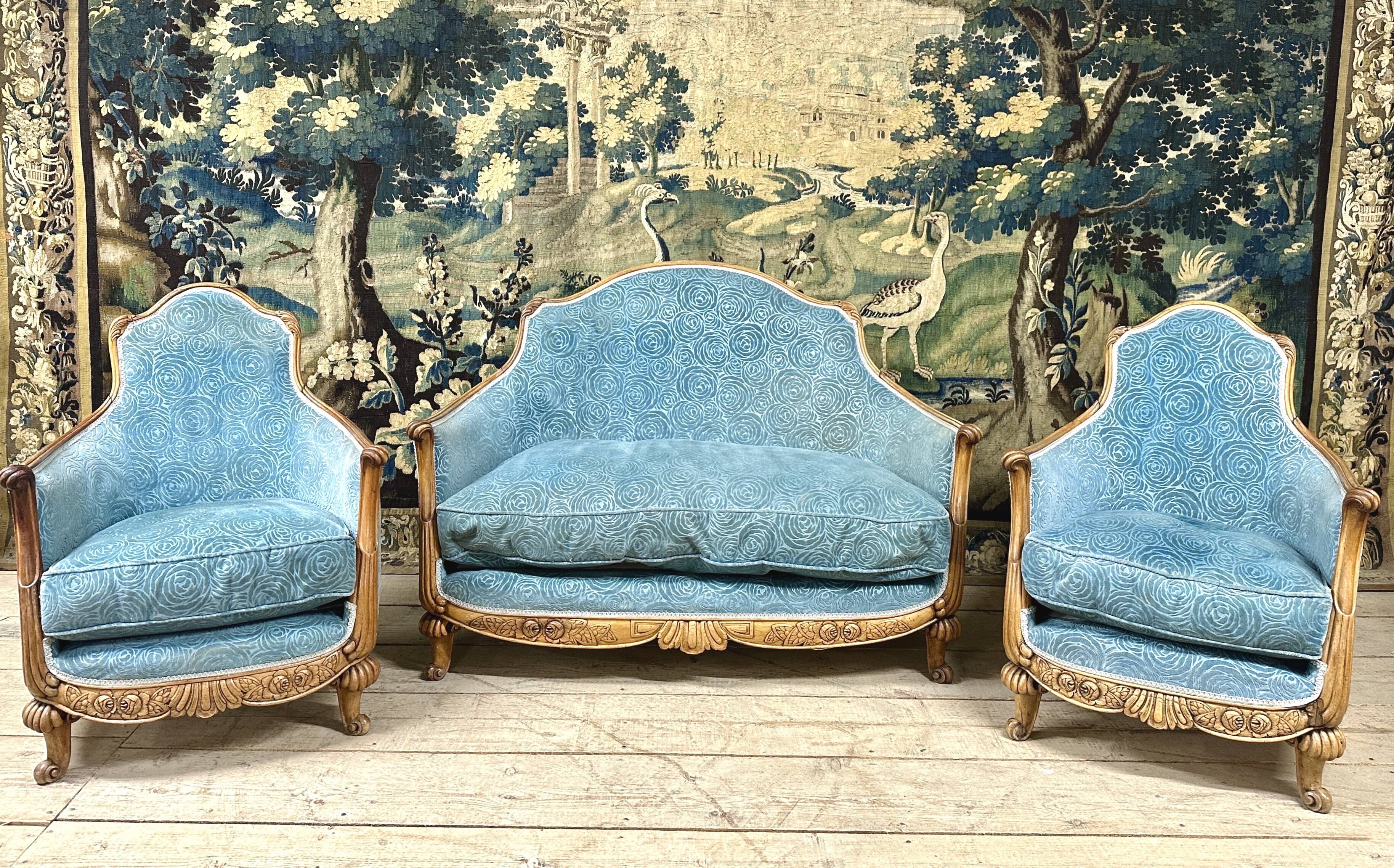 Art deco living room around 1920 in carved wood upholstered in blue velvet, a sofa two armchairs