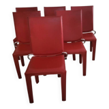 Red leather dining chairs by Arper