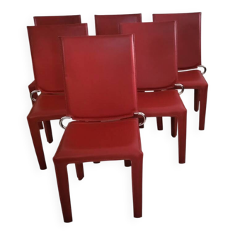 Red leather dining chairs by Arper