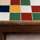 19th century oak farm table with multi-colored ceramic tiles