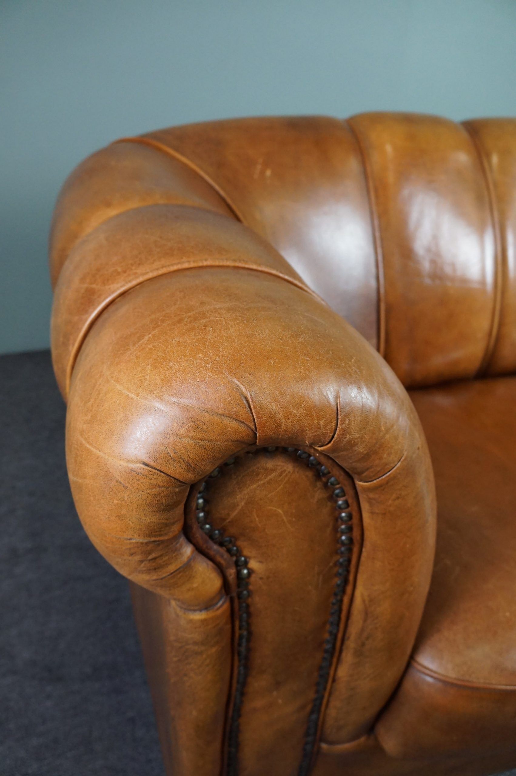 Sheepskin sofa with decorative nails