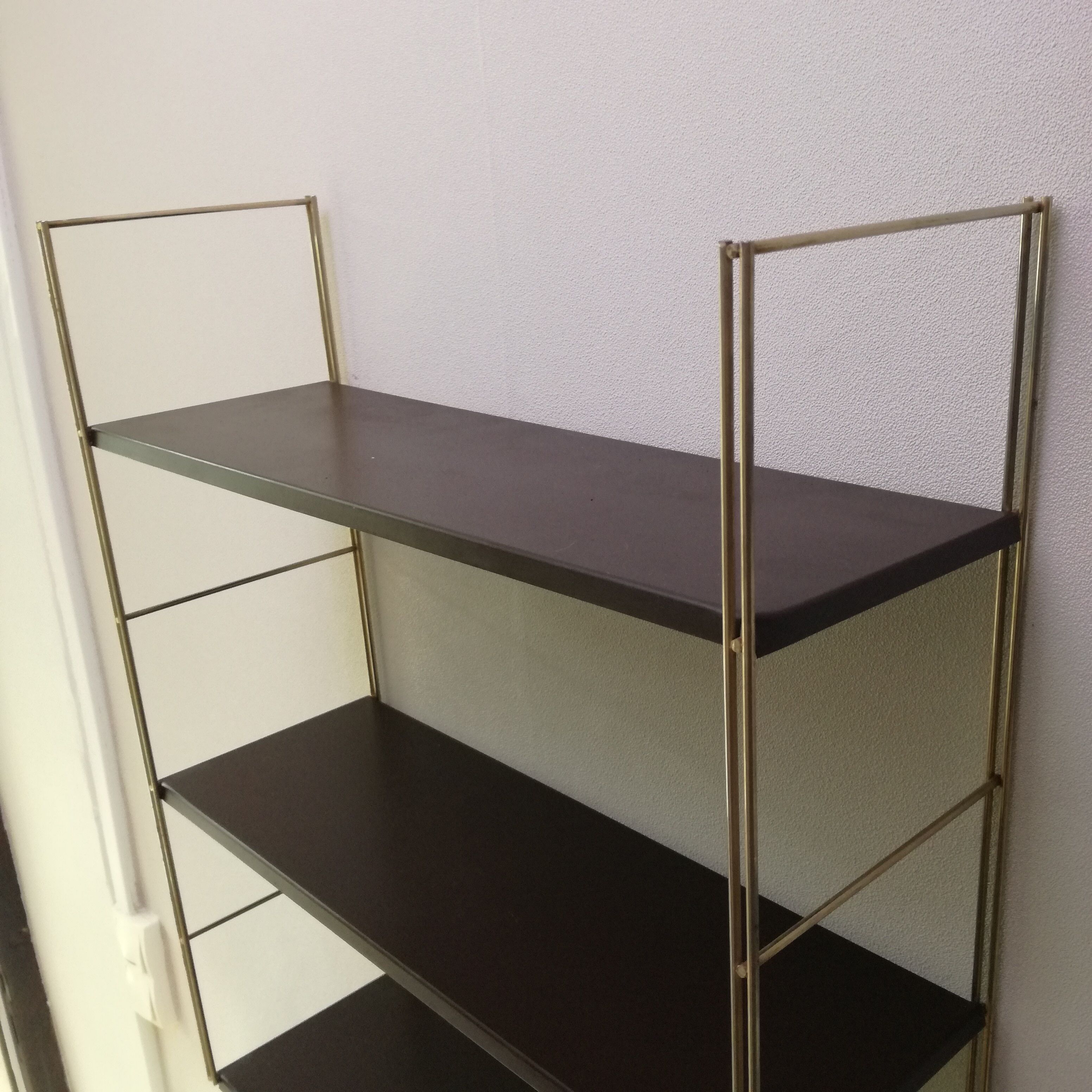 Golden and brown stringed shelf in metal