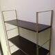 Golden and brown stringed shelf in metal