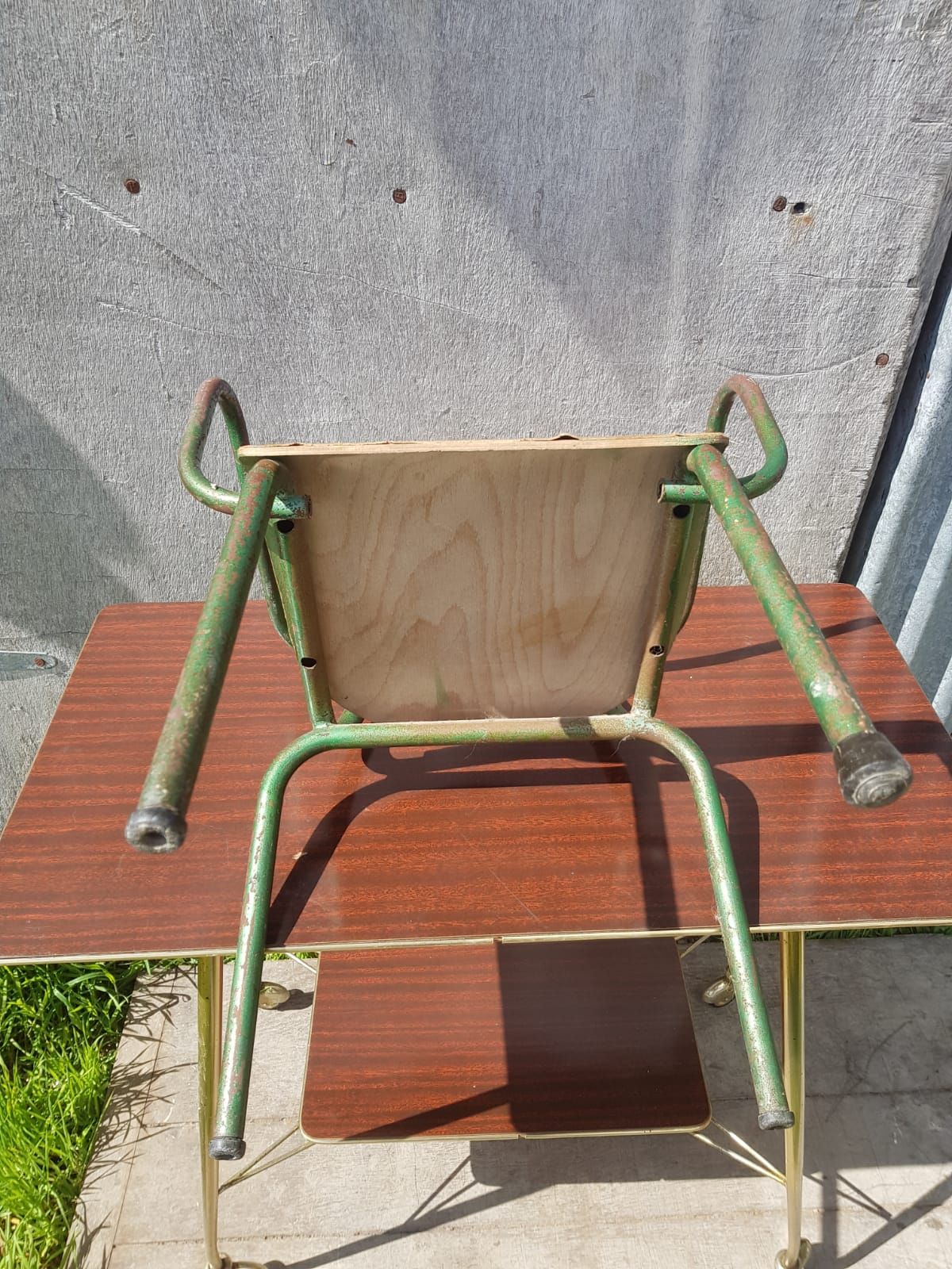 Former green metal child chair