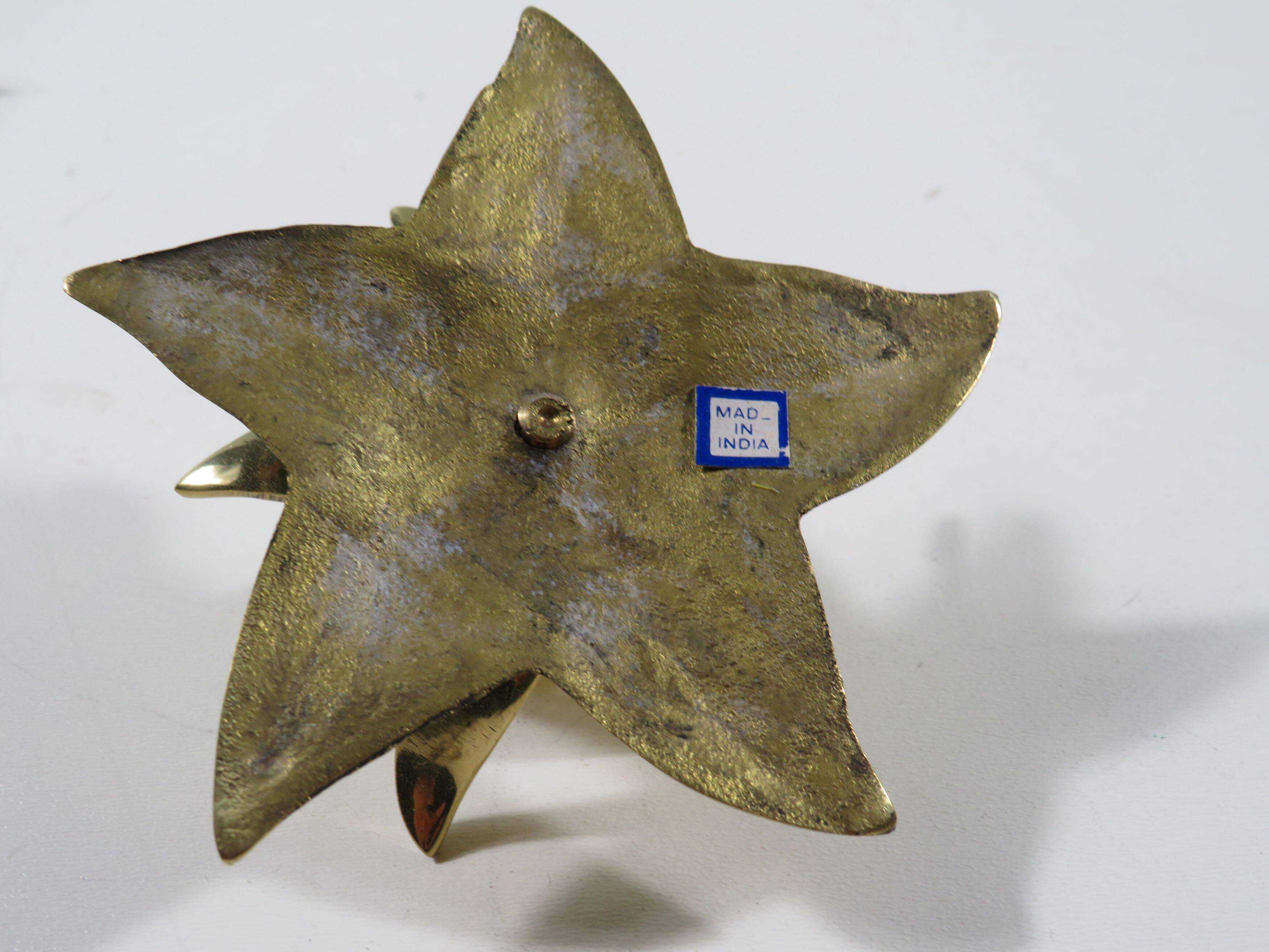 Set of 7 heavy shiny brass flower shaped candle holders, 1970-1980