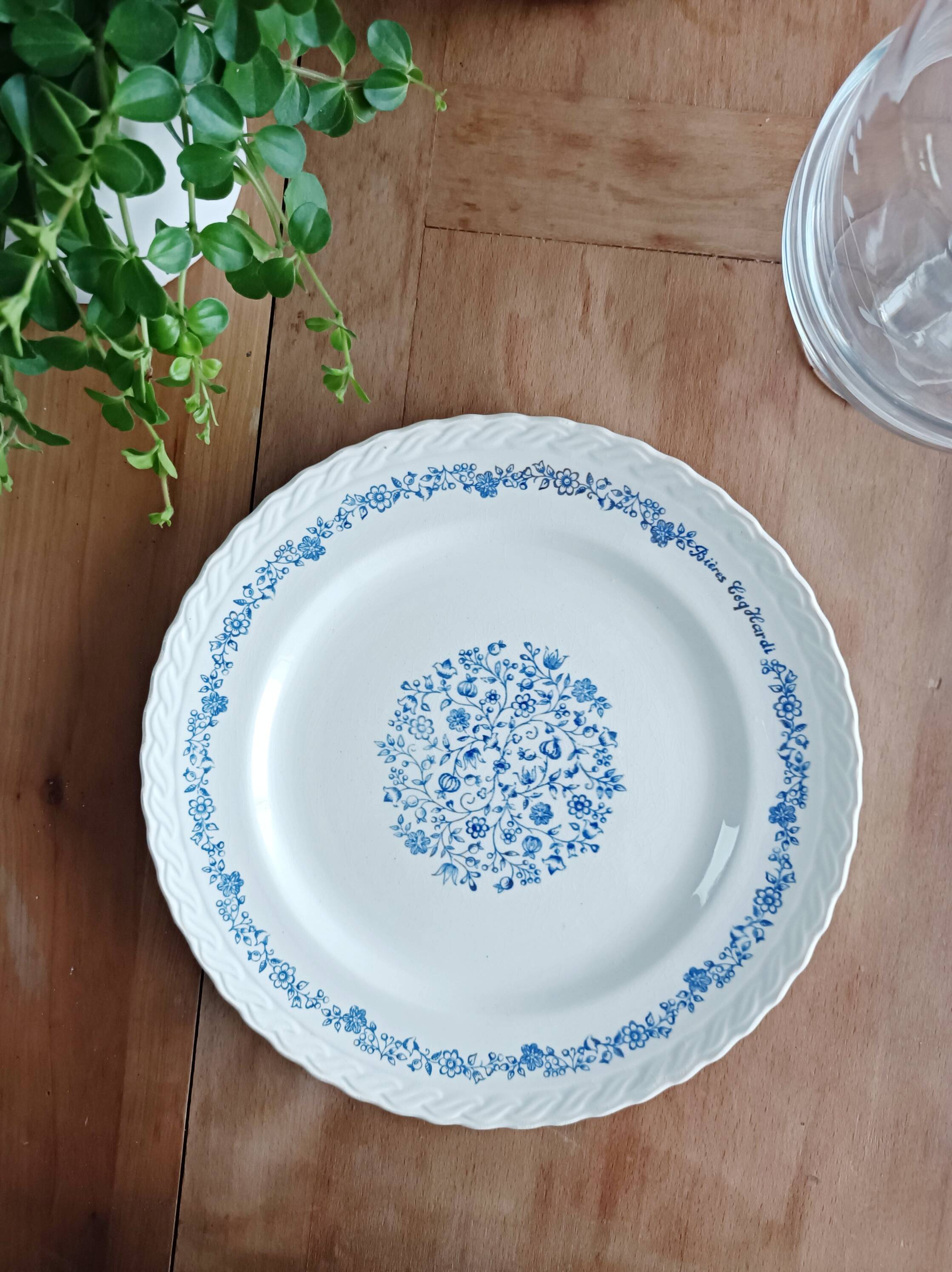 Round antique earthenware dish with floral decoration