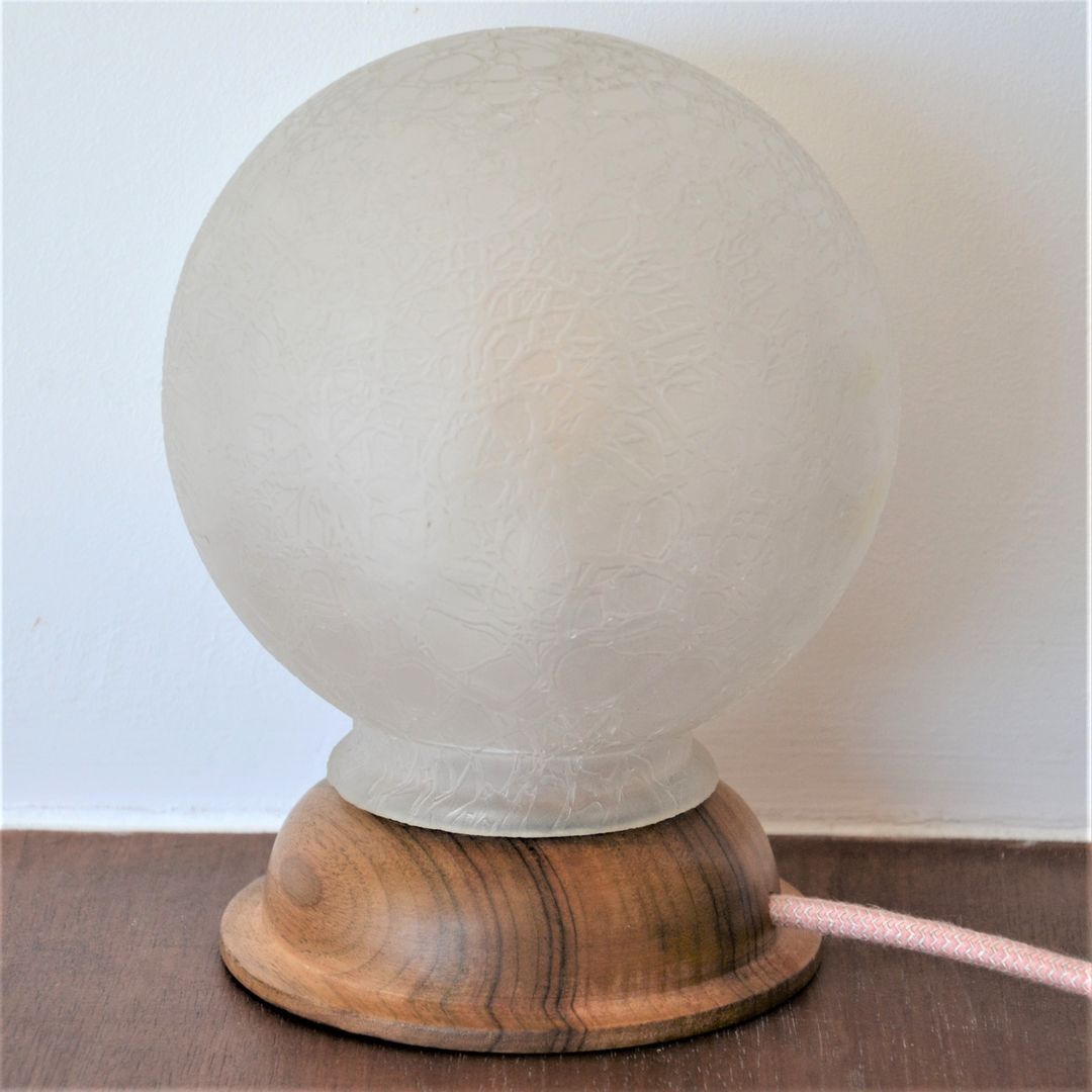 White glass globe table lamp with geometric reliefs