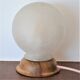 White glass globe table lamp with geometric reliefs