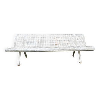 Old perforated metal garden bench
