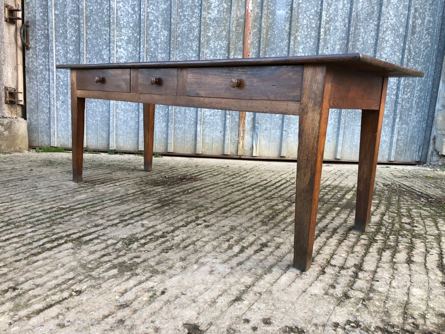 Antique chestnut farmhouse table with 3 drawers on the front.