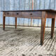 Antique chestnut farmhouse table with 3 drawers on the front.