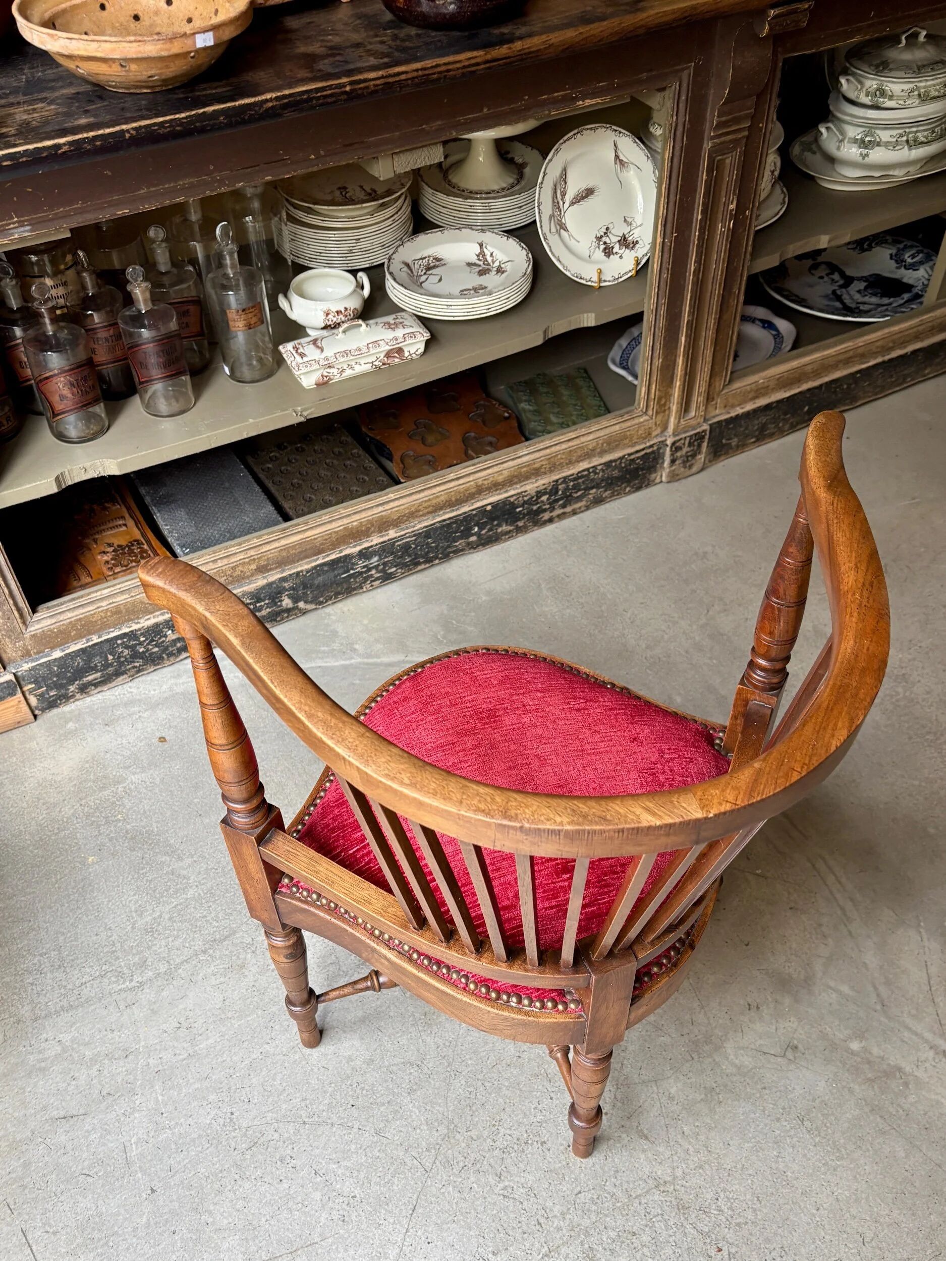 Corner armchair, dark wood and red velvet office chair.