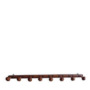 Wall-mounted coat rack with 8 turned wooden hooks in faux bamboo style.