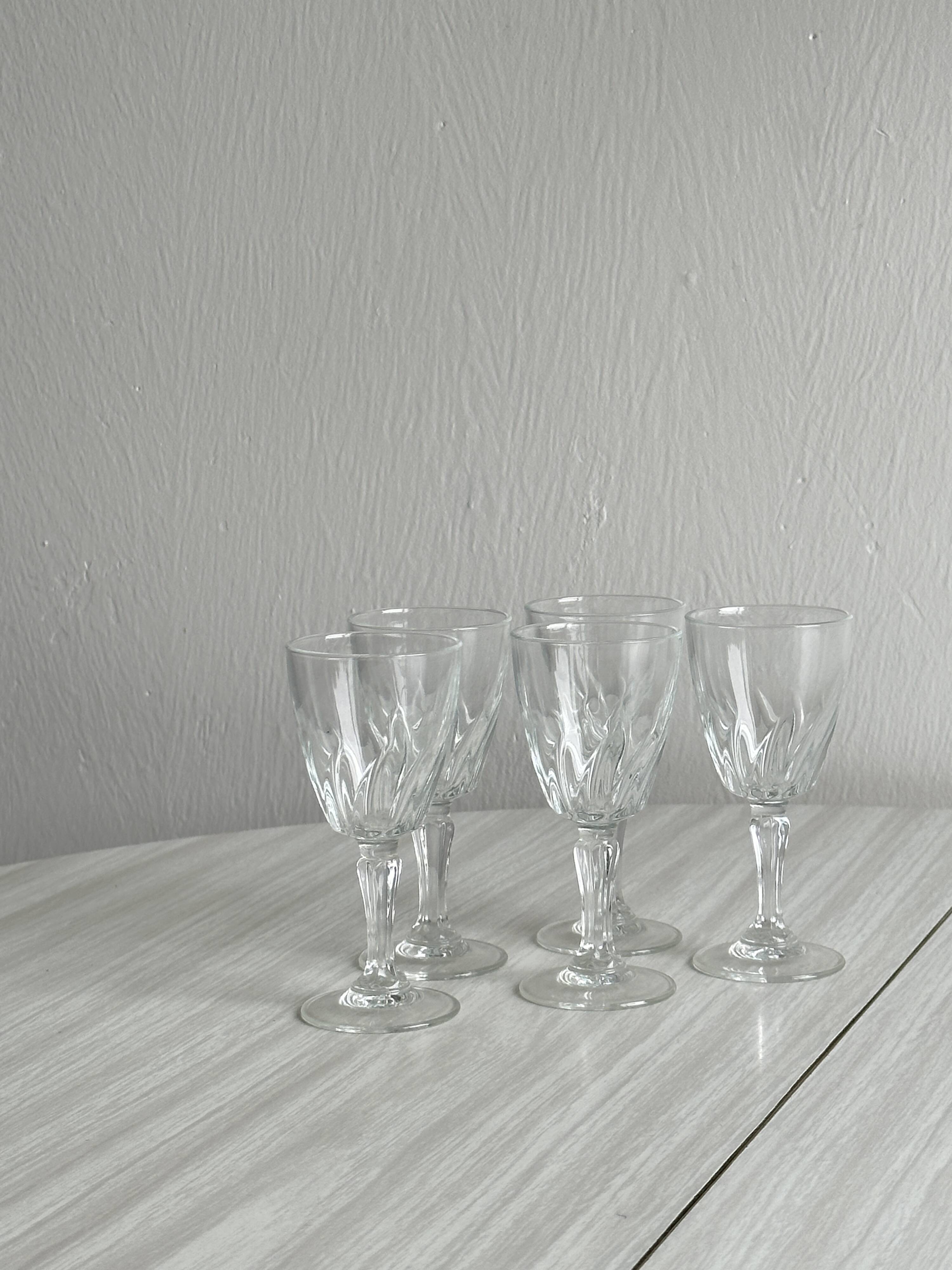 5 clear crystal liqueur glasses.
