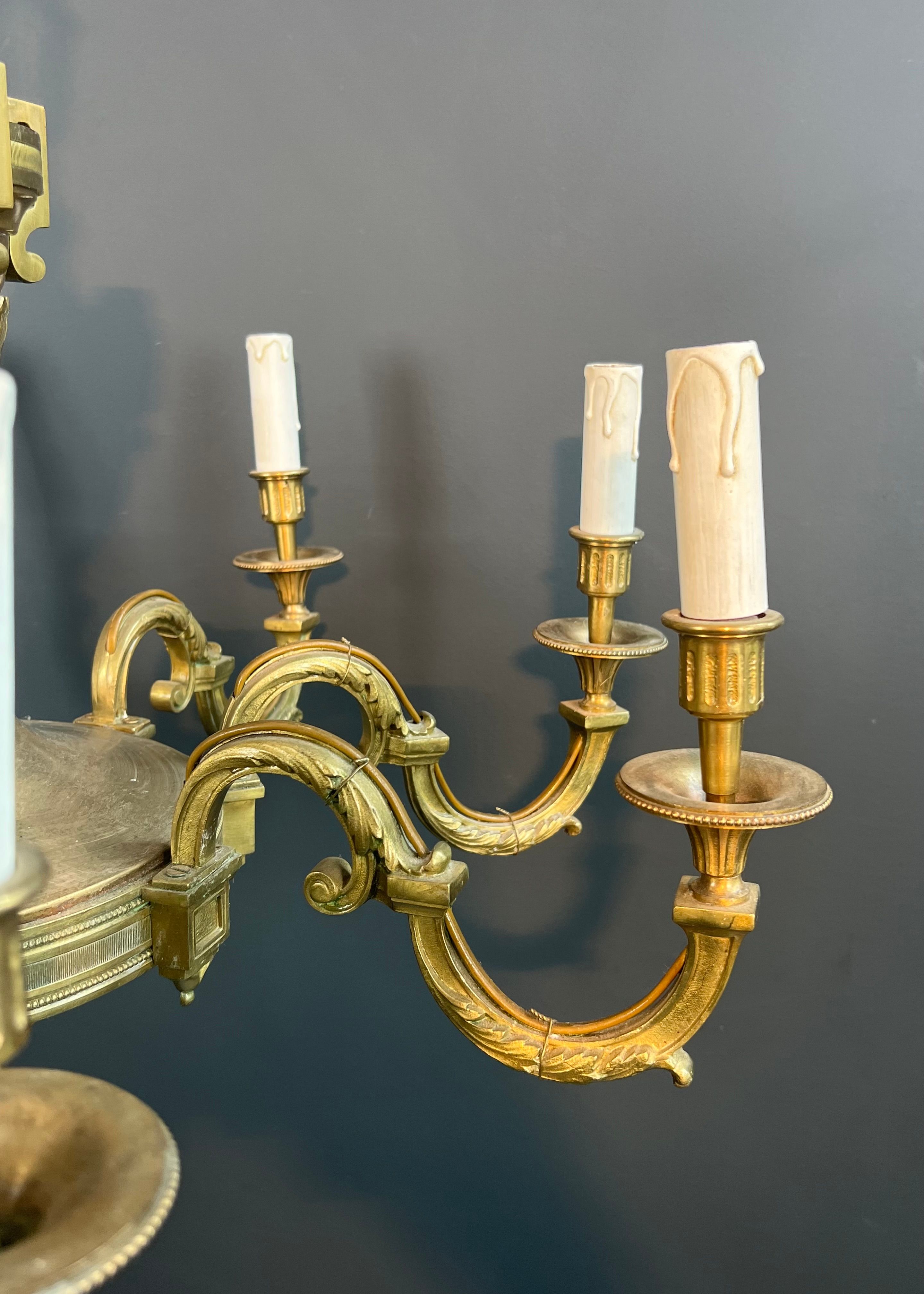 Important Louis XVI style chiseled bronze chandelier with 8 light arms by Lucien Gau
