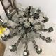 Old-fashioned country-style chandelier with virgin vine and bunch of grapes.