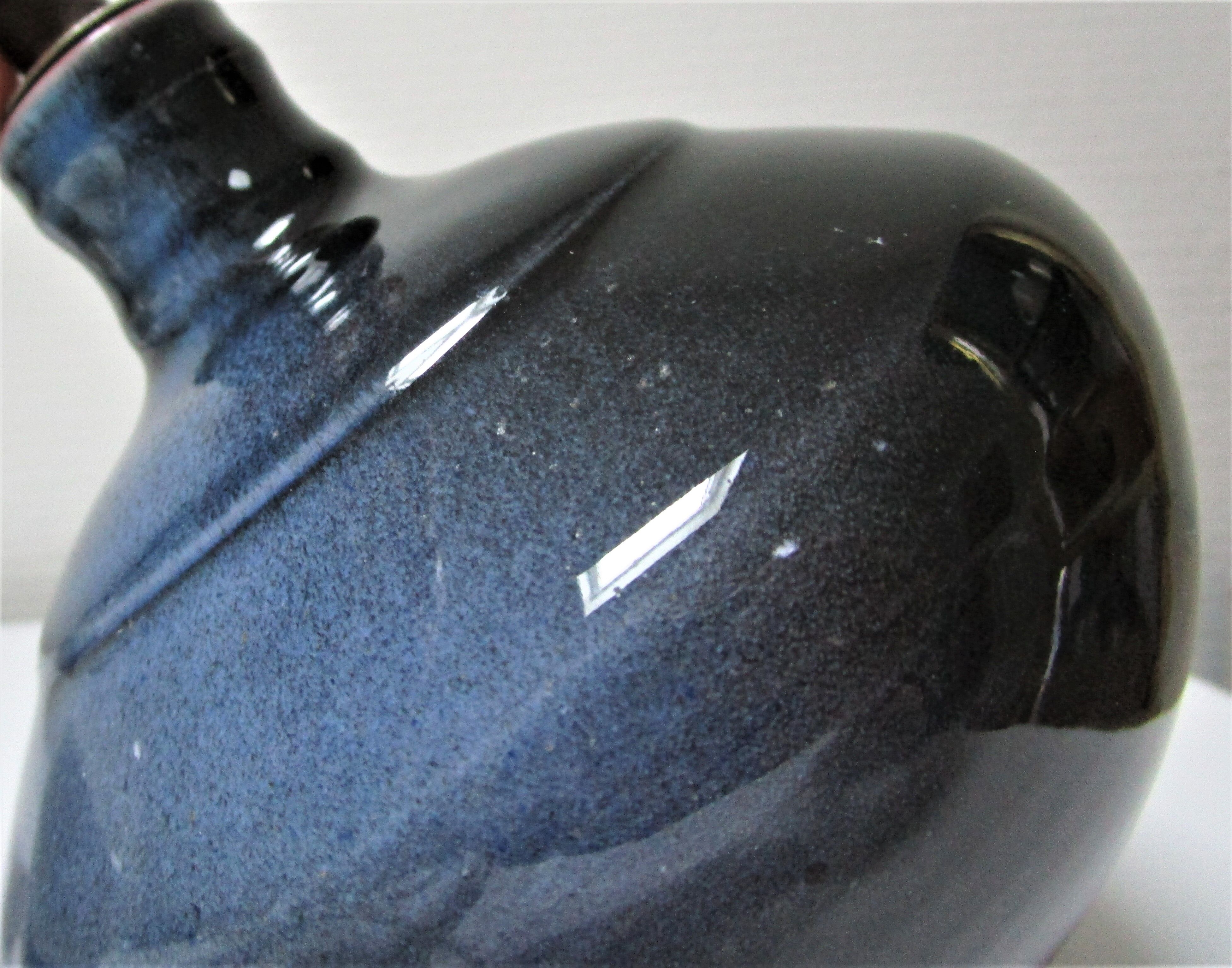 Three vintage ceramic lamps in blue, white and suede