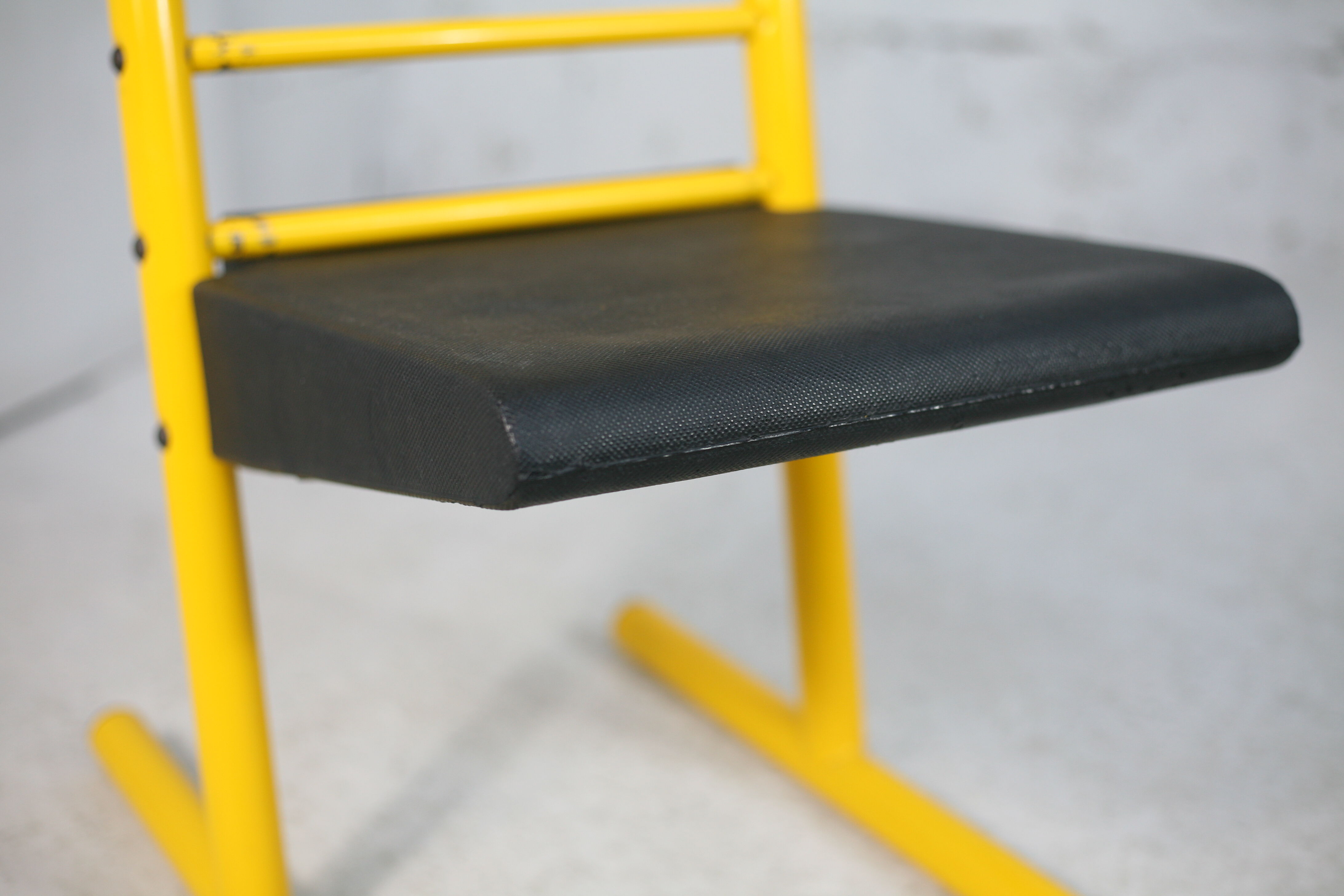 Adjustable seat chair. Circa 1980. Italy. Yellow lacquered steel.