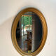 Oval mirror in gilded wood