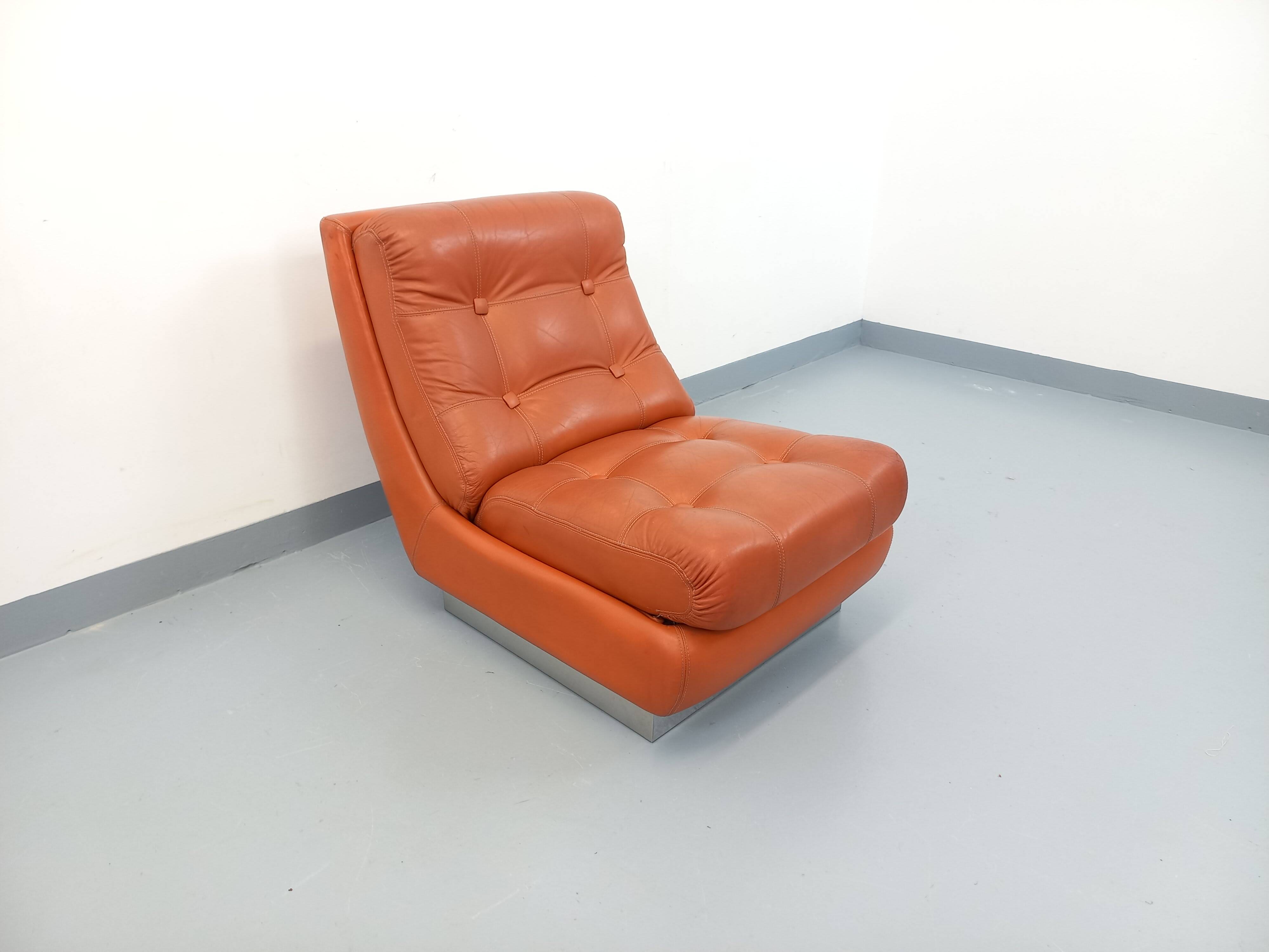 Vintage Roche Bobois armchair in chrome and terracotta leather.