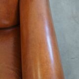 Very beautiful complete set consisting of a sheepskin leather sofa and two armchairs in cognac color