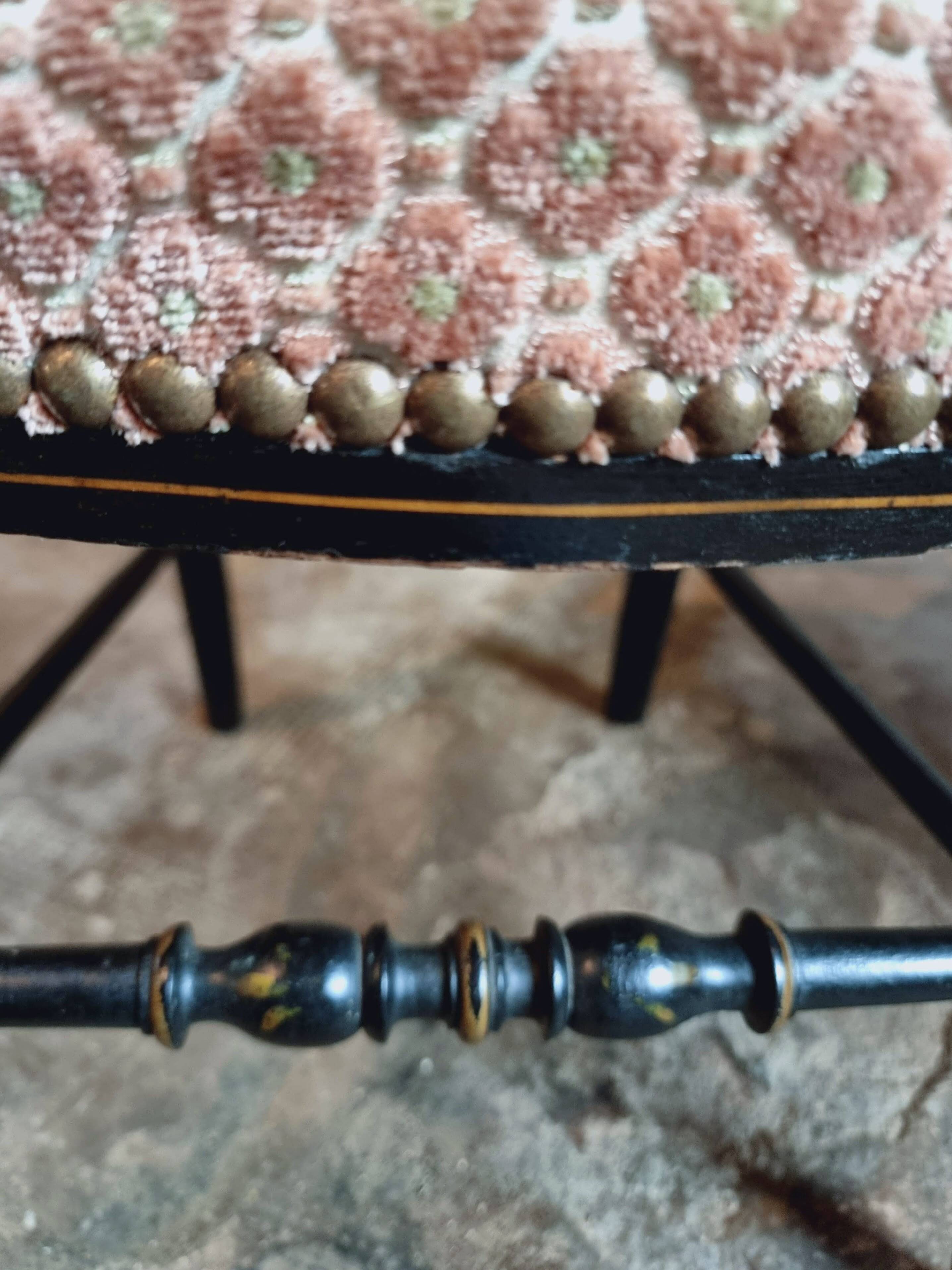 Pair of antique Napoleon III chairs in blackened wood and fabric.