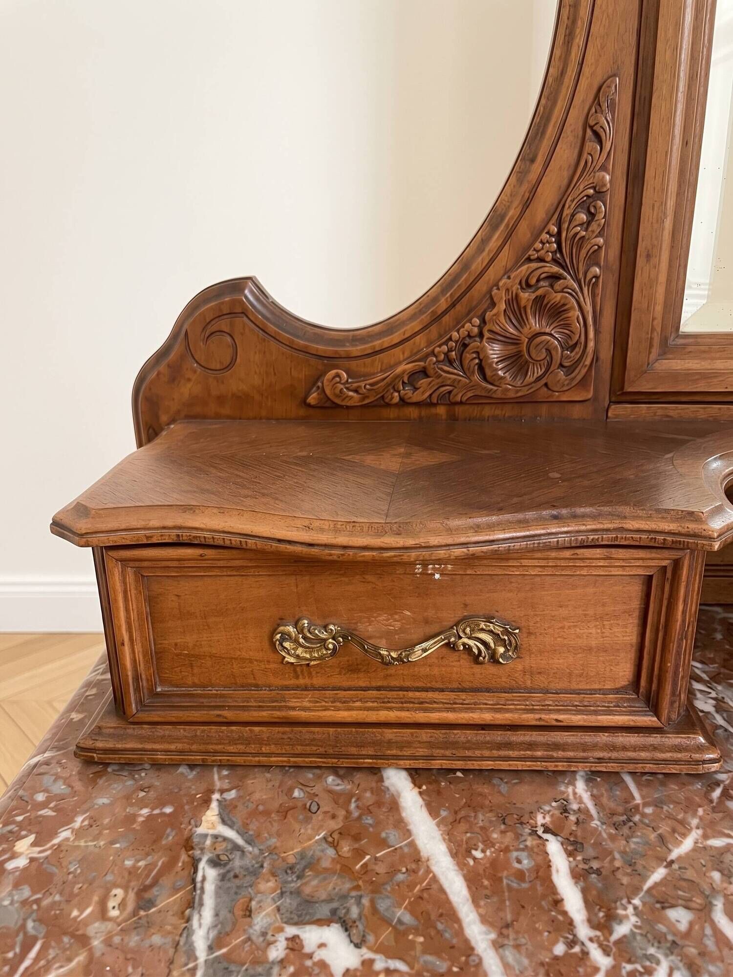 Antique carved wooden dressing table with marble and mirror.