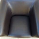 2 club armchairs with a chocolate faux leather seat and backrest and wooden legs.